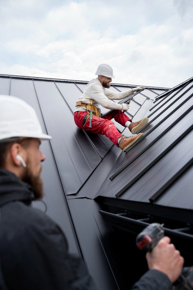 Roofing Pro LA crew installing standing seam metal roof on residential property in Los Angeles