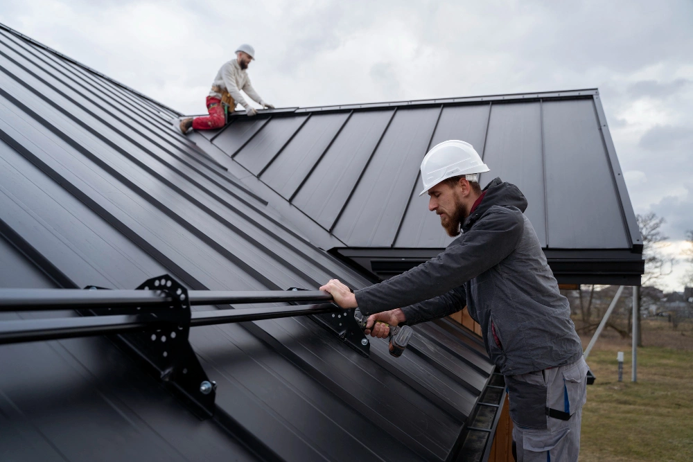 Roofing Pro LA specialists repairing standing seam metal roofing system on a modern Los Angeles home